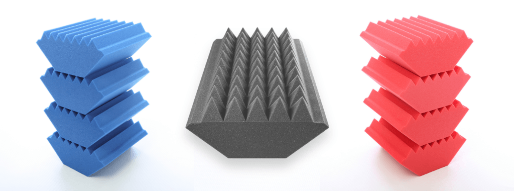 A selection of SoundFix Bass Traps. Stack of 4 blue wedge profile traps left, large pyramid profile bass trap grey middle and 4 red wedge profile bass traps right.